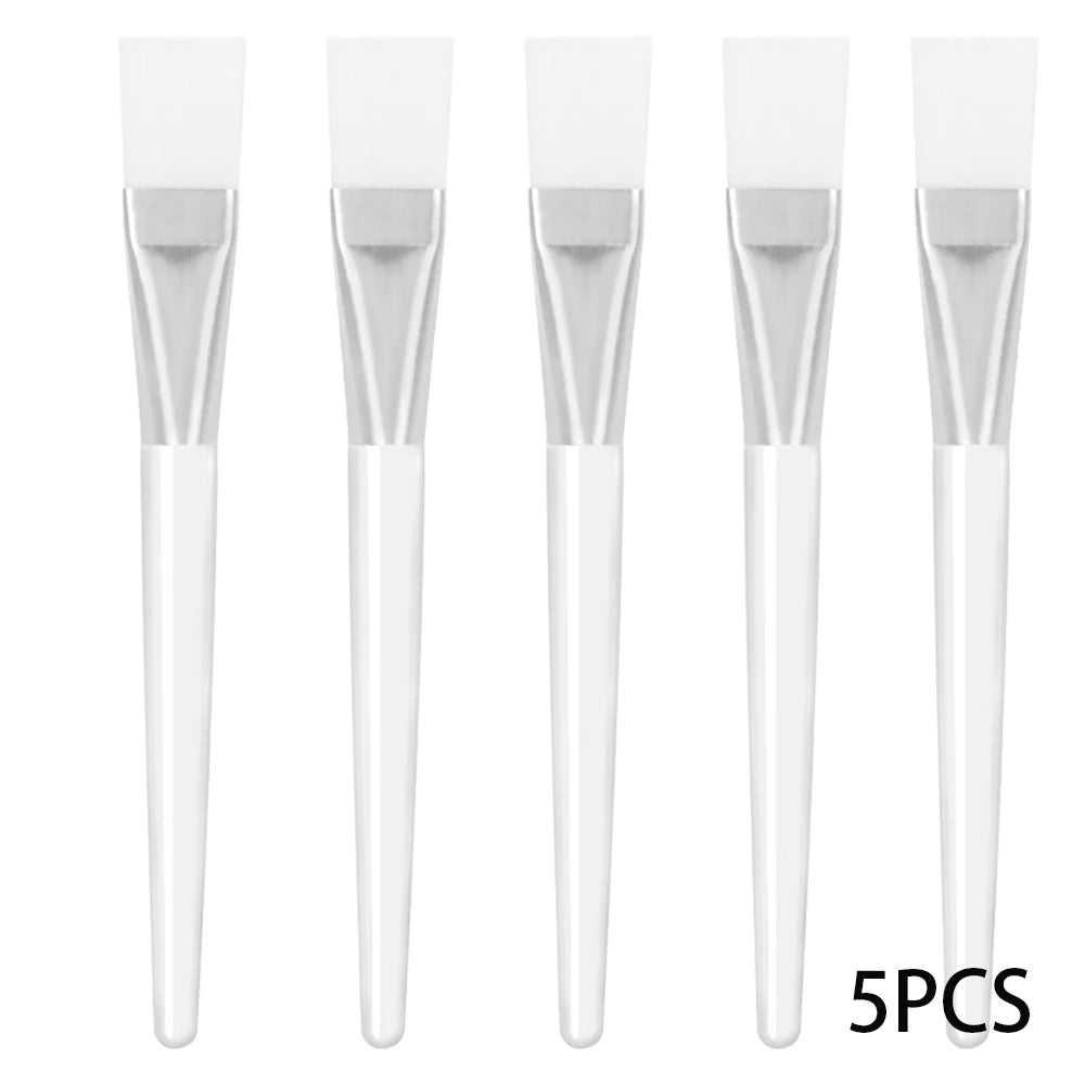 Five facial mask brushes with white silicone heads, silver ferrules, and translucent white handles.