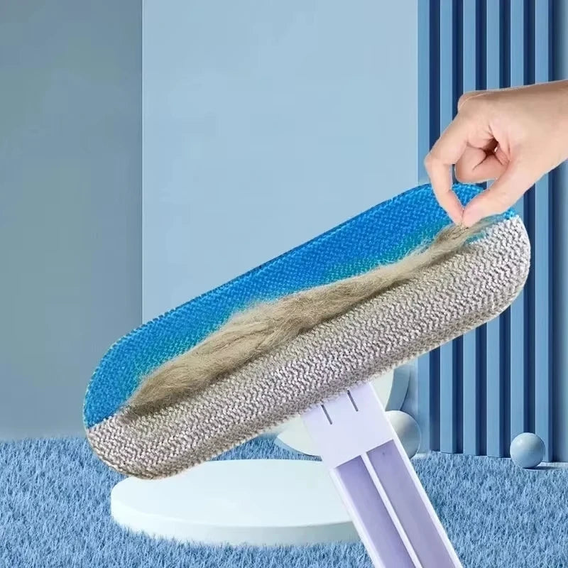 Manual blue and gray pet hair remover brush effectively cleaning fur from carpets and furniture.