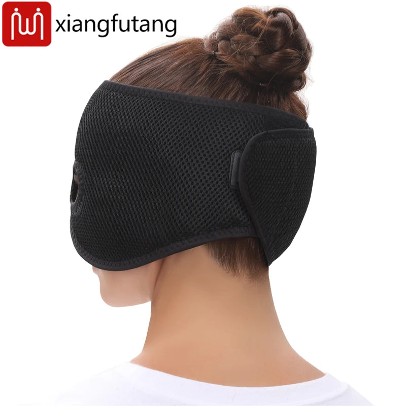 A person wearing a black, mesh-textured, half-face heating mask that wraps around the back of the head with a strap.