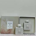 Amouage Love Tuberose white perfume bottles in elegant gift box set. Luxury floral oriental fragrance packaging.