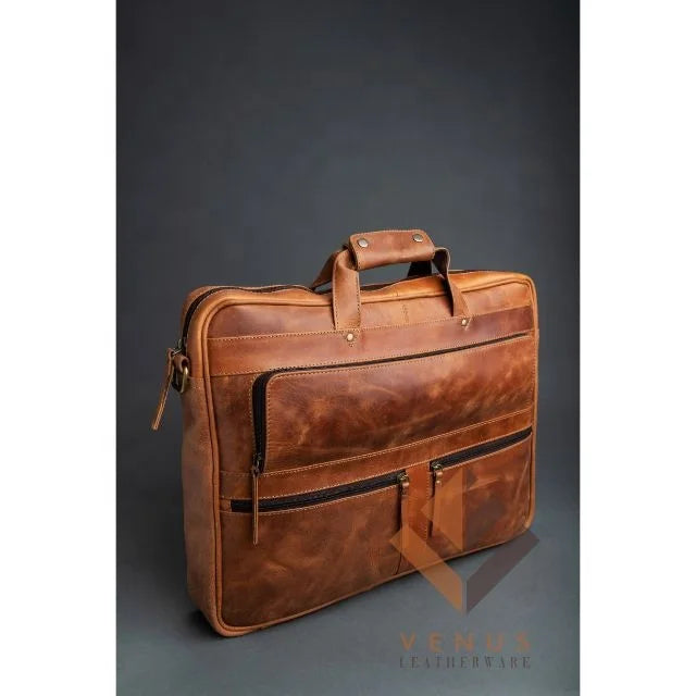 Tan genuine leather men's business briefcase with top handles, zippered front pockets, and detachable shoulder strap.