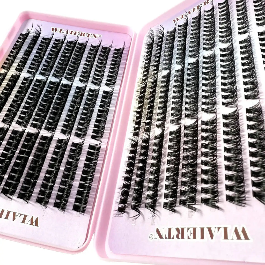 Black false eyelash clusters in a pink plastic tray for professional eyelash extension application.