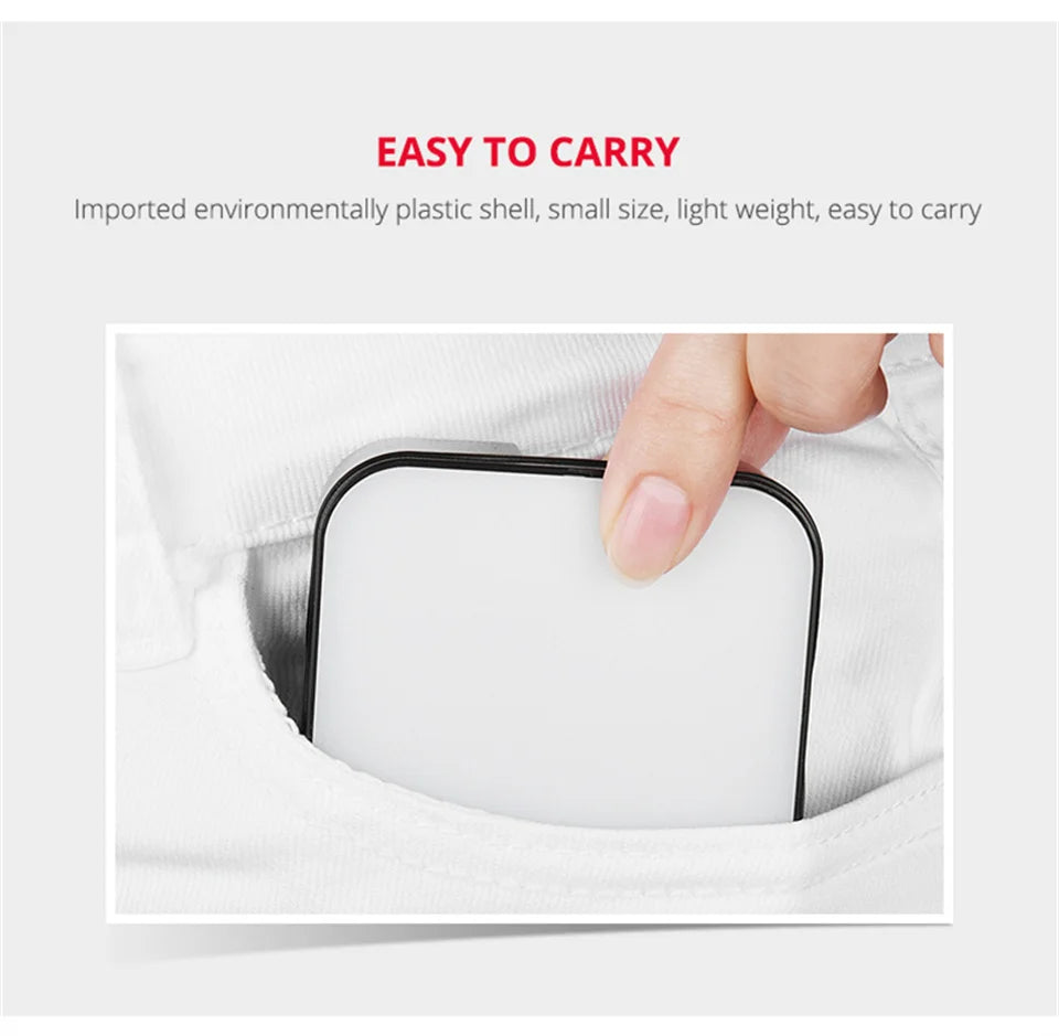 Small, square white plastic LED fill light being pulled from a jeans pocket. Portable, compact lighting accessory.