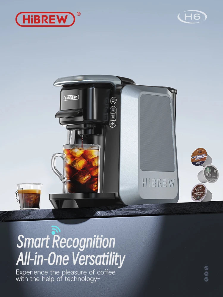 HiBREW H6 smart pod coffee maker in silver and black brewing iced coffee with capsules on a dark kitchen counter.