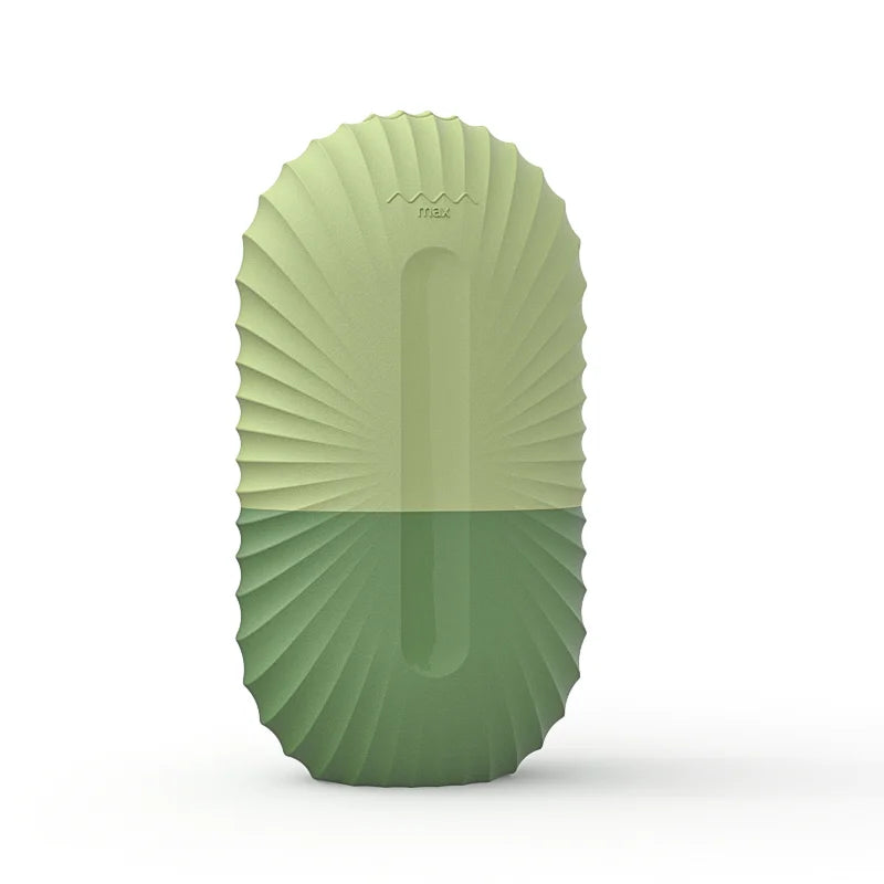 An oval, silicone ice roller mold in two-tone green with a ribbed, sunburst-textured exterior and a 'max' fill line.
