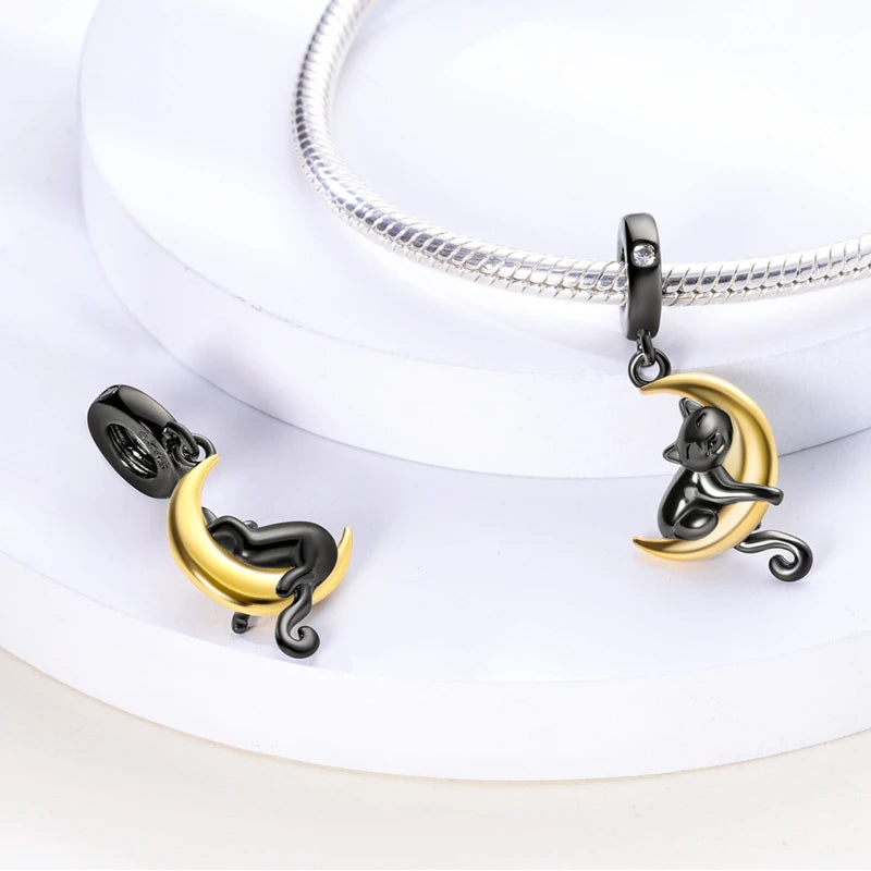 925 silver cat and moon dangle charms for bracelets. Cute black and gold pet jewelry perfect for DIY charm bracelets.