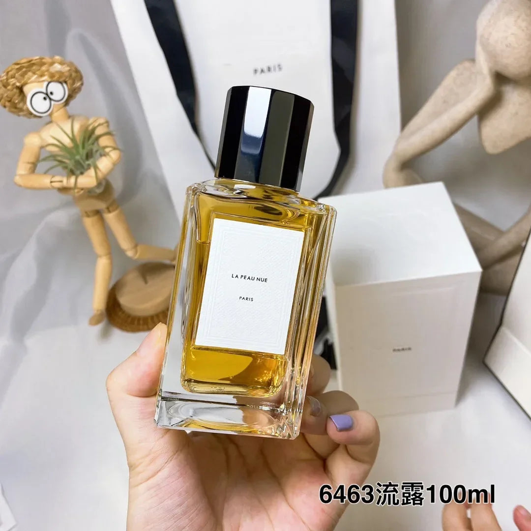 La Peau Nue Paris unisex perfume in a rectangular glass bottle with black cap. Long-lasting, 100ml luxury fragrance.