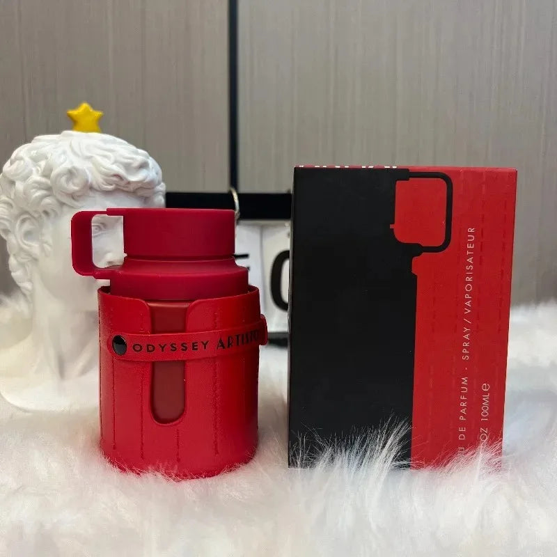 Armaf Odyssey Artistic unisex woody EDP perfume. Red leather-wrapped cylindrical bottle with matching box, 100ml spray.