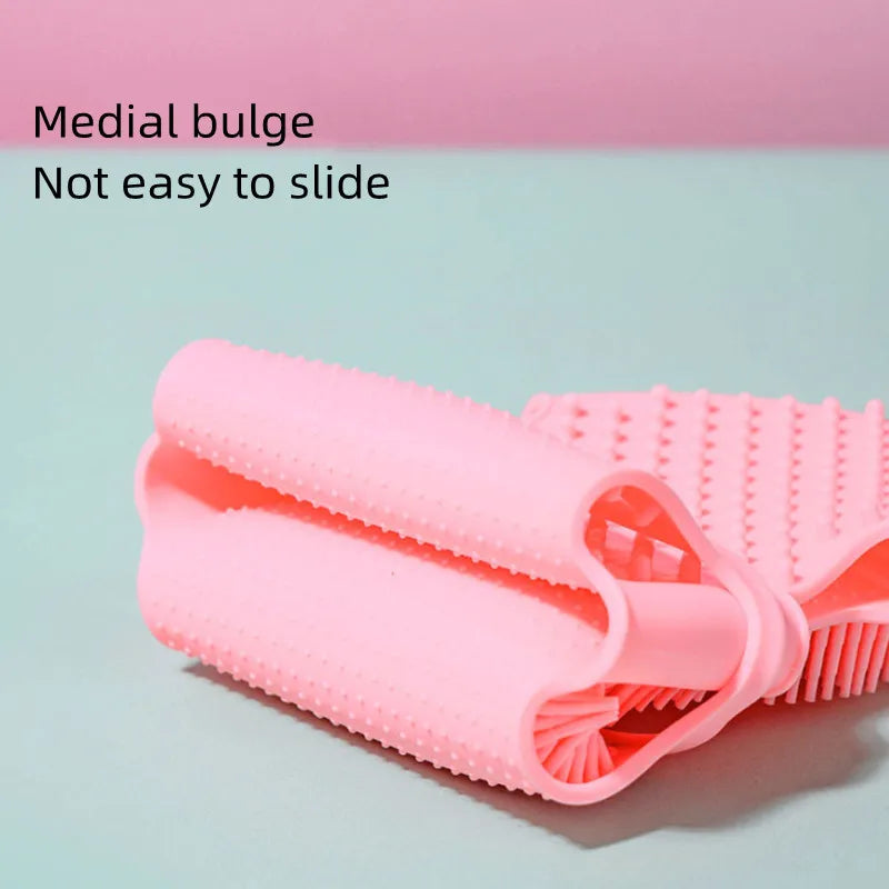 Pink silicone pet bath brush and massage glove for gentle grooming and exfoliation with non-slip grip.