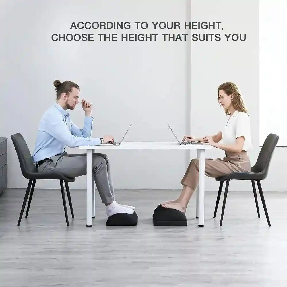 Adjustable black memory foam foot rest under desk for office ergonomic back and hip pain relief.