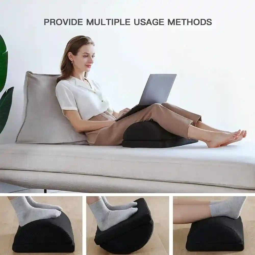 Black adjustable memory foam foot rest used as a desk leg stool or lap pillow for back and hip pain relief.