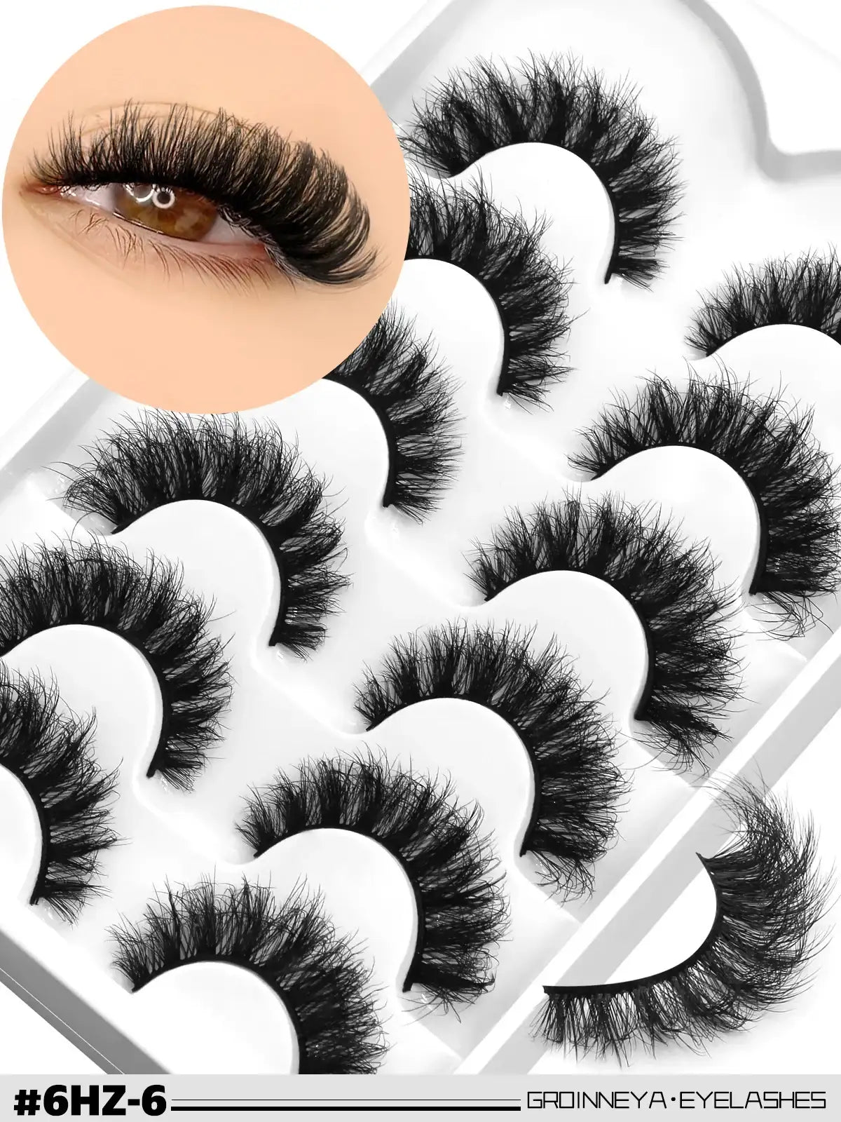 Pack of 5 pairs of black 3D mink false lashes with wispy, voluminous cat-eye style on a white display tray.