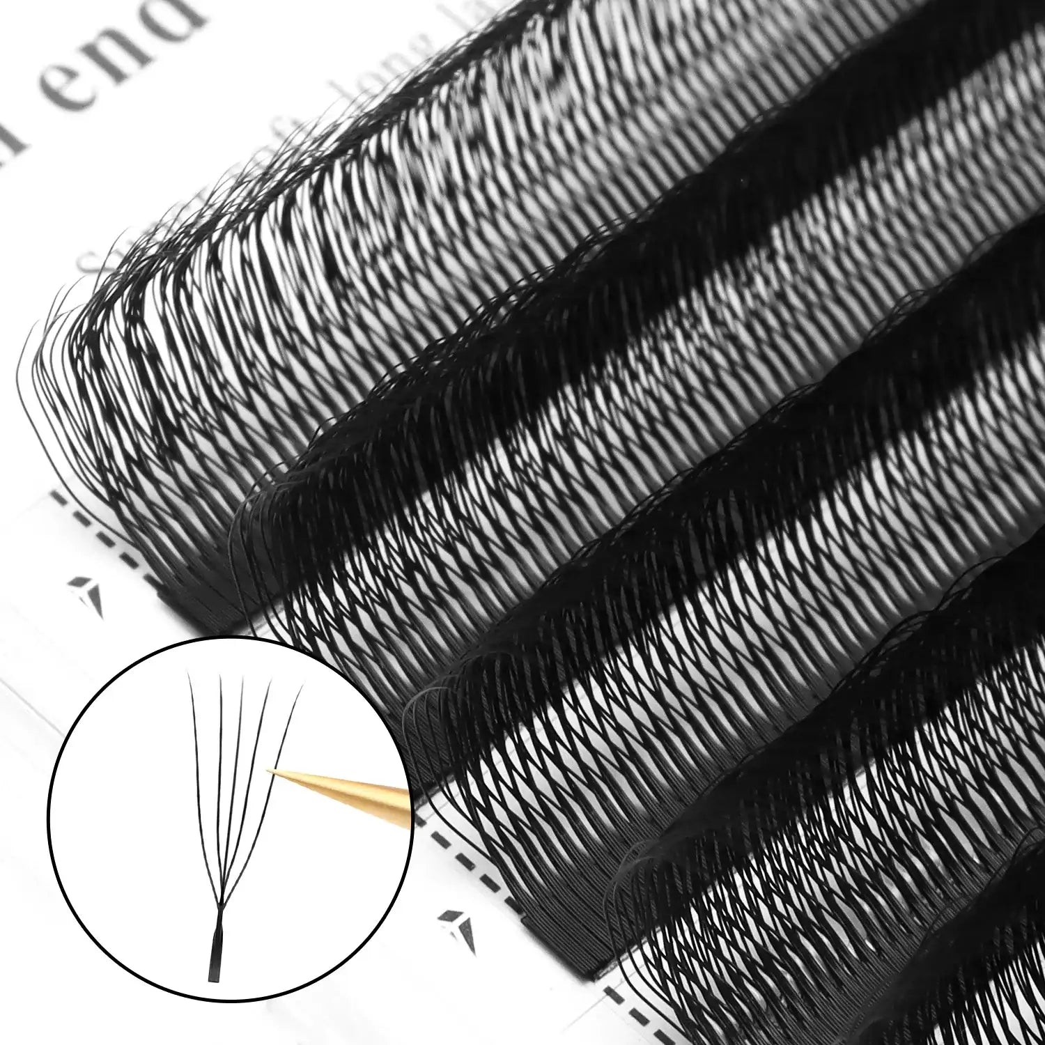 Black eyelash extension strips on a tray, showing fine synthetic fiber fans for professional volume application.