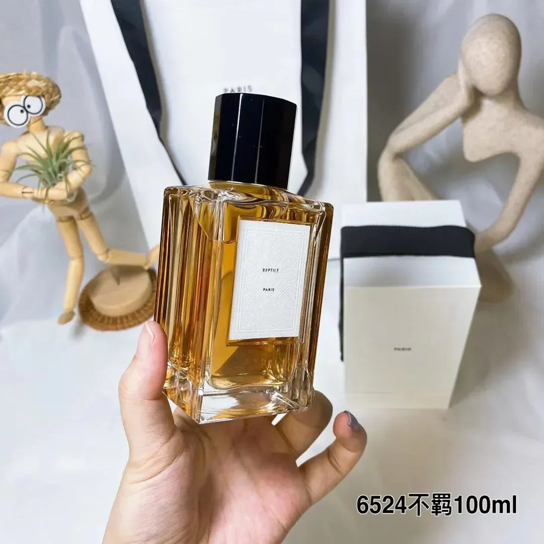 Reptile Paris 100ml unisex perfume. Sleek square glass bottle, amber scent, long-lasting luxury fragrance for men/women.