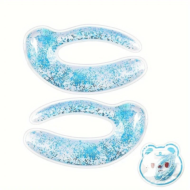 Two C-shaped blue glitter gel eye patches and one small bear-shaped compress on a white background.