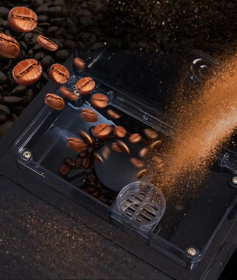 Coffee beans falling into a sleek black automatic espresso machine grinder hopper.