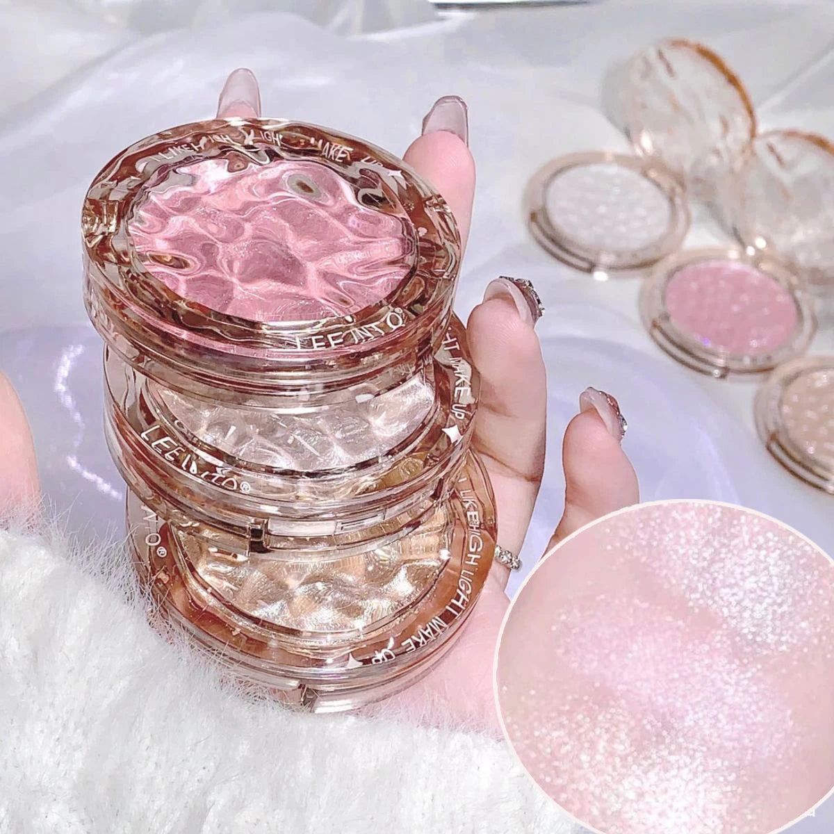 Tidesmit LEE INTO highlighter powder texture close-up featuring pearlescent fine shimmer and silky mashed potato finish