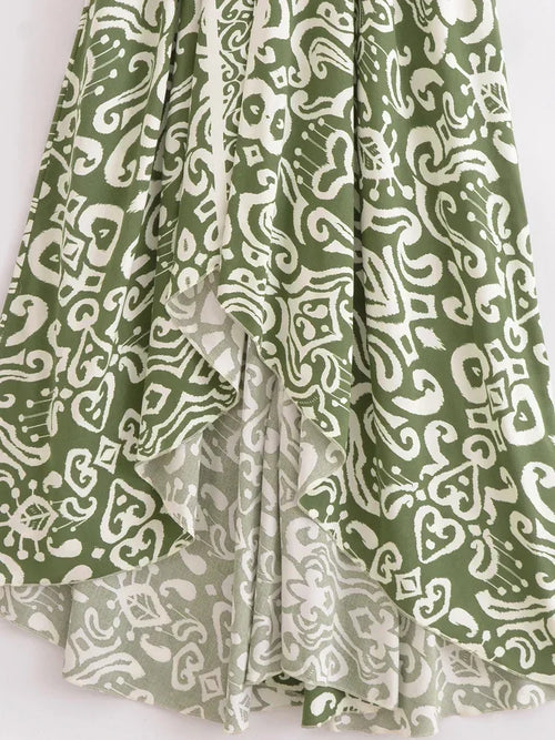 Geometric print bohemian high-low maxi dress in olive green and white, featuring a draped skirt for resort wear.