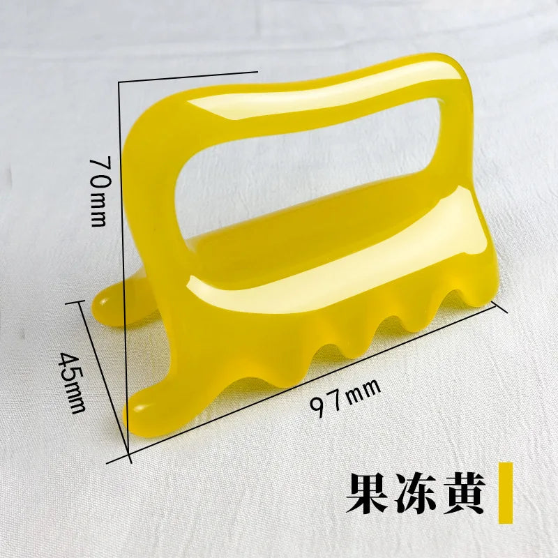 Yellow resin five-pronged massage tool for muscle relief, 97mm wide by 70mm tall with a loop handle.