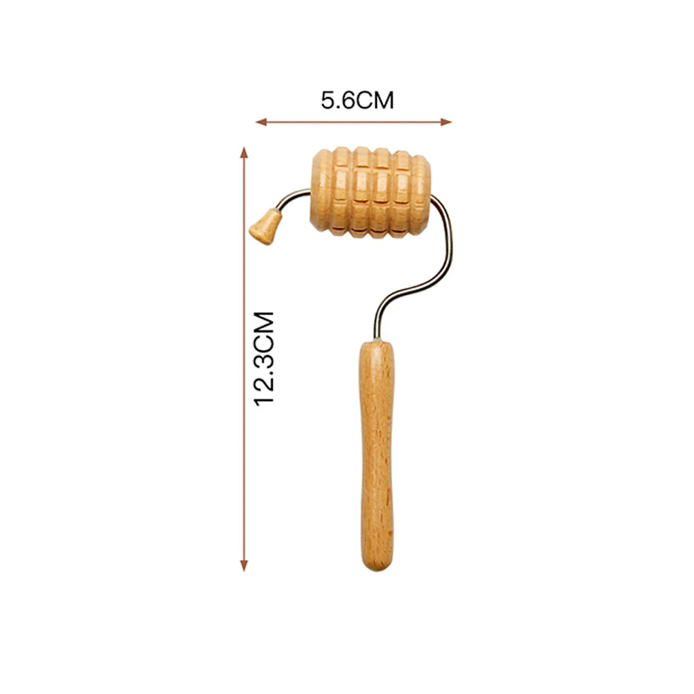 Wooden facial massage roller with a textured, ribbed barrel on a metal frame, showing dimensions 5.6cm by 12.3cm.