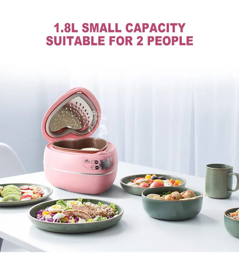 Pink mini rice cooker with open inner pot showing heart-shaped cooking surface