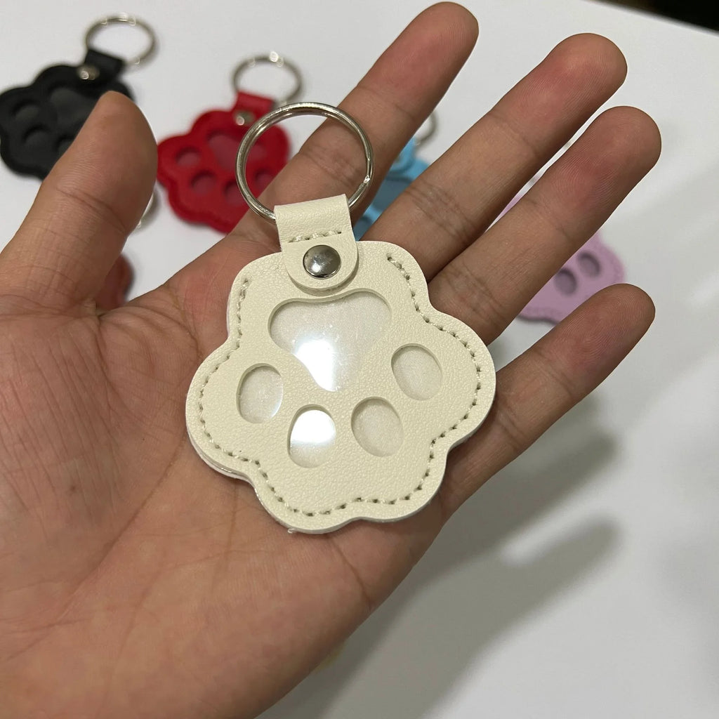 White leather cat paw keychain for pet hair storage, a portable multifunctional bag pendant for cat lovers.