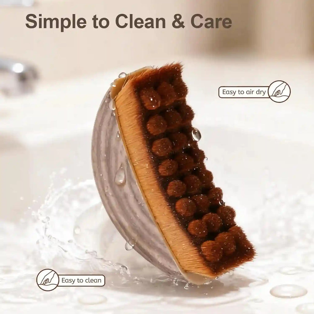 Contour facial brush with a grey ergonomic base and textured brown bristles, shown wet in a sink.