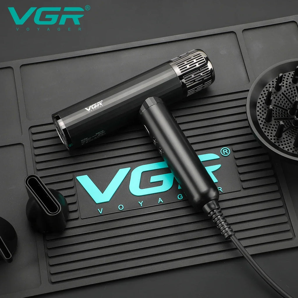 VGR V-427 professional brushless hair dryer in black with diffuser and concentrator attachments on a salon mat.