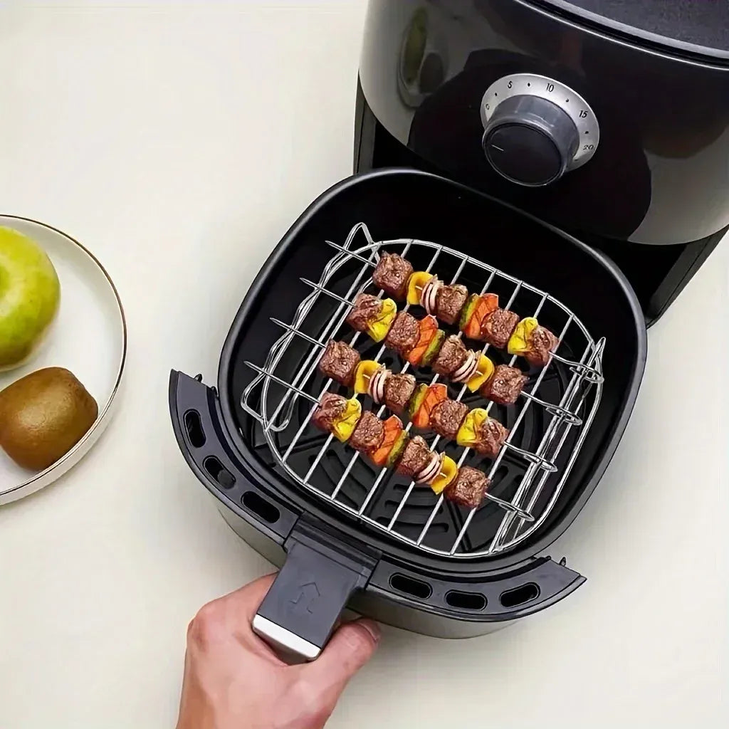 Square air fryer grilling rack accessory with four skewers loaded with meat and colorful peppers