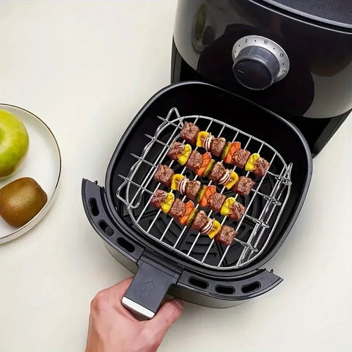 Square air fryer grilling rack accessory with four skewers loaded with meat and colorful peppers